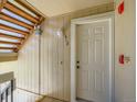 Close-up of a unit entrance door with a wooden staircase leading up to the next level at 7700 N Depew St # 1518, Arvada, CO 80003