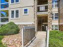 Charming condo building with stone accents, stairs, and a walking bridge entrance at 7700 N Depew St # 1518, Arvada, CO 80003