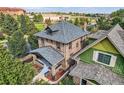 An aerial view of the brick home highlighting the roof and surrounding landscaping at 2854 Eliot St, Denver, CO 80211
