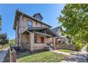 Traditional two-story brick home with a covered front porch and well-maintained front yard at 2854 Eliot St, Denver, CO 80211