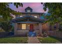Beautiful two-story brick home with a welcoming front porch and well-manicured lawn at 2854 Eliot St, Denver, CO 80211