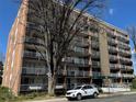 Exterior of multi-story condo with balconies, landscaping, and street parking, showcasing urban living at 4801 E 9Th Ave # 108S, Denver, CO 80220