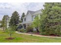 Charming two-story home surrounded by lush greenery and a well-maintained lawn at 31 N Algonquian St, Aurora, CO 80018