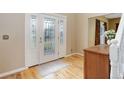 Bright foyer with hardwood floors, an ornate glass front door, and a staircase in the background at 31 N Algonquian St, Aurora, CO 80018