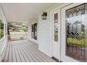 Spacious front porch with decorative railing and a stylish front door with glass inserts at 31 N Algonquian St, Aurora, CO 80018