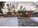 Mid-century modern home with a carport and snowy front yard at 6127 S Westview St, Littleton, CO 80120