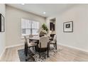 Cozy dining room with hardwood floors, a round table with upholstered chairs, and natural light at 10137 Atlanta St, Parker, CO 80134