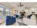 Comfortable living room with plush seating, modern fireplace, and view of the backyard at 10137 Atlanta St, Parker, CO 80134