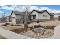 Charming home featuring a rock and mulch landscaped yard with neutral color palette and covered porch at 16224 Cirque Mountain Way, Broomfield, CO 80023