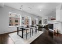Open-concept dining room with large windows, modern lighting, and views into an adjacent living space at 1940 Blake St # 300, Denver, CO 80202