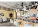 Spacious kitchen with stainless steel appliances and granite countertops, open to the dining area at 2100 16Th St # 606, Denver, CO 80202