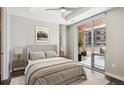Serene bedroom with neutral tones, a comfortable bed, and a view of the balcony at 4200 W 17Th Ave # 223, Denver, CO 80204