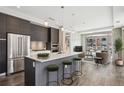 Modern kitchen with stainless steel appliances, kitchen island with barstool seating, and an open floor plan at 4200 W 17Th Ave # 223, Denver, CO 80204