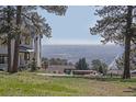 Backyard view featuring a hot tub and seating with a beautiful view of the city in the distance at 21531 Main Ave, Golden, CO 80401