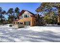 Log home exterior, back view, hot tub on patio; snowy yard at 21531 Main Ave, Golden, CO 80401