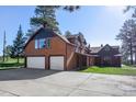 Two story home with an attached two car garage, a covered porch and well manicured lawn at 21531 Main Ave, Golden, CO 80401