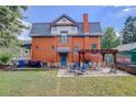 Spacious backyard features a patio with a pergola and seating area at 209 10Th Ave, Idaho Springs, CO 80452