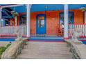 Inviting front porch with colorful decorations and ornate railing at 209 10Th Ave, Idaho Springs, CO 80452