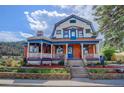Charming Victorian home with a colorful exterior and inviting front porch at 209 10Th Ave, Idaho Springs, CO 80452