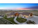 Custom home featuring sprawling acreage, meticulous landscaping, and an oversized garage at 12565 Picadilly Rd, Commerce City, CO 80022