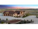 Stunning estate showcasing a spacious driveway, three-car garage, and stone detailing at 12565 Picadilly Rd, Commerce City, CO 80022