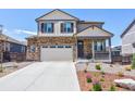 Attractive two-story home with stone accents, a covered porch, and a two-car garage on a sunny day at 9 N Waterloo St, Aurora, CO 80018
