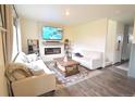 Bright living room with cozy seating, fireplace, mounted TV, and stylish decor at 9 N Waterloo St, Aurora, CO 80018