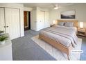 Virtually staged bedroom with light grey carpet and ample closet space at 1885 S Quebec Way # B23, Denver, CO 80231
