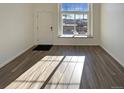 Bright living room with large window and hardwood floors at 1885 S Quebec Way # B23, Denver, CO 80231