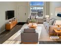 Virtually staged living room featuring modern furniture and hardwood floors at 1885 S Quebec Way # B23, Denver, CO 80231