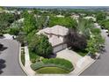 Aerial view of a beautiful home with mature trees, a spacious driveway, and manicured landscaping at 11433 Decatur Ct, Westminster, CO 80234