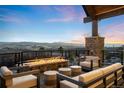 Outdoor patio featuring a cozy fire pit and comfortable seating, perfect for enjoying scenic mountain views at 3148 Keep Dr, Sedalia, CO 80135