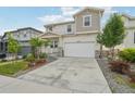 Two-story home boasting a two-car garage, a covered porch, and a well-manicured lawn at 8926 Swan River St, Littleton, CO 80125