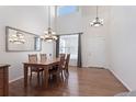 Spacious dining area with hardwood floors, chandelier, and a large mirror at 9878 Mulberry Way, Highlands Ranch, CO 80129