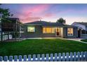 Single-story home featuring a well-maintained lawn, picket fence, and playhouse at 4329 S Clarkson St, Englewood, CO 80113