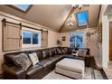 Cozy living room with vaulted ceiling, skylights, modern decor, and a comfortable sectional sofa at 4329 S Clarkson St, Englewood, CO 80113