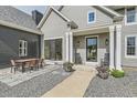Home exterior with covered porch, outdoor dining set, and walkway at 7401 Deerfield Rd, Longmont, CO 80503