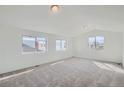 Bright and spacious bedroom with carpet and multiple windows at 6906 Kendrick Ln, Arvada, CO 80007