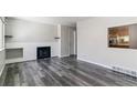 Bright living room with hardwood floors and fireplace at 1202 S Troy St, Aurora, CO 80012