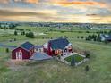 An aerial view of the home showing the fenced in backyard and the surrounding green pastures and community at 3124 Antelope Ridge Trl, Parker, CO 80138
