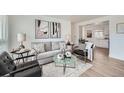 Cozy living room with neutral-toned sofa, modern art, and stylish accent furniture at 1649 Lima St, Aurora, CO 80010