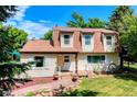 Quaint two-story home with decorative wagon wheel accenting the lovely front yard landscaping at 1813 Pikes Peak St, Erie, CO 80516