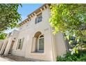 Charming stucco home with architectural details and landscaped front yard, featuring prominent address display at 22933 E Ontario Dr # 105, Aurora, CO 80016