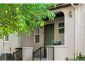 Inviting front entrance featuring a covered porch, decorative plants, and a well-maintained garden at 22933 E Ontario Dr # 105, Aurora, CO 80016