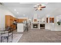Open-concept living space with a cozy fireplace and seamless flow to the kitchen area and breakfast bar at 22933 E Ontario Dr # 105, Aurora, CO 80016