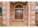 Close-up of a brick front door entrance with decorative glass and light fixtures at 3970 Pierson St, Wheat Ridge, CO 80033