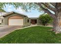 Charming brick home featuring manicured lawn, and covered entry at 2588 S Flower Ct, Lakewood, CO 80227