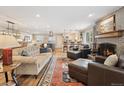 Bright and spacious living room featuring a fireplace and an open floor plan at 2588 S Flower Ct, Lakewood, CO 80227