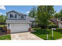 Inviting front exterior featuring a well-maintained lawn and a spacious two-car garage at 13464 Vine St, Thornton, CO 80241