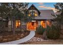 Charming home featuring a stone facade, a welcoming front door, and beautiful landscaping for enhanced curb appeal at 1052 Country Club Estates Dr, Castle Rock, CO 80108